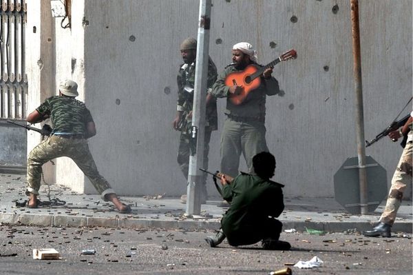 playing a guitar during a gunfight