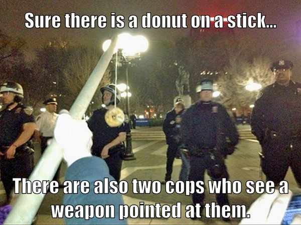 Sure there is a donut on a stick...
 There are also two cops who see a weapon pointed at them.